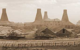 The four bottle houses at the southern end of the site, Gallery Row at right. 1870