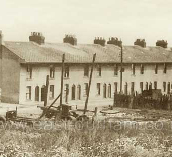 Gallery Row, built around 1850 for bottleworks employees at southern end of bottleworks site, demolished c 1960 . Later the site of Derek Mercer's scrap metal business 1969-99. By the time this photograph was taken, probably 1930s, the gallery (veranda) on the upper storey of this side of the street had been removed.