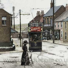 Hetton Front Street, about 1910. The Sunderland District tram has been renumbered 31 but it is really number 8. This tram had been involved in a fatal accident on Botcherby bank at Silksworth. They kept it in the car sheds for two years then sent it out renumbered so that nobody would know it was the 'unlucky' tram.  Hand coloured photograph and caption from Malcolm Fraser.