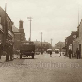 Front Street Hetton in the 1930s. This is looking north-north-westward at a point near the church or chapel, which is out of sight to the right.  There is or was a Wesleyan Chapel behind the photographer. Partially hidden by the more distant of the two single-deck buses is what later became Hetton Library but at the time of the photograph it would have been a school.  
Caption by Sheldon Clark
