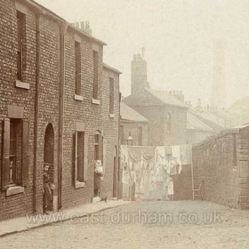 Detail from NSand 001 showing the wasing drying in the street, must be a Monday.