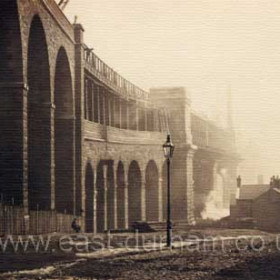 New bridge and Times Inn, Wear Street. This is the north end of the Alexandra Bridge while under construction in 1909. The brick arches carry the rail line on the upper deck away from the        lower deck roadway which, hidden behind the arches, curves in the other direction towards Southwick. The rail line was used for coal trains from Washingon to the docks until it fell out of use in 1921 and was subsequently removed from the bridge as was most of this brickwork. The bridge has just been extensively renovated and remains a very important road alternative to Wearmouth bridge. 
Photo Norman Kirtlan, info Len Charlton